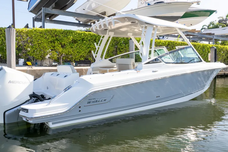 Slide: The Image of 2023 Boston Whaler 280 Vantage boat docked, showcasing sleek design and dual Mercury engines. - 28