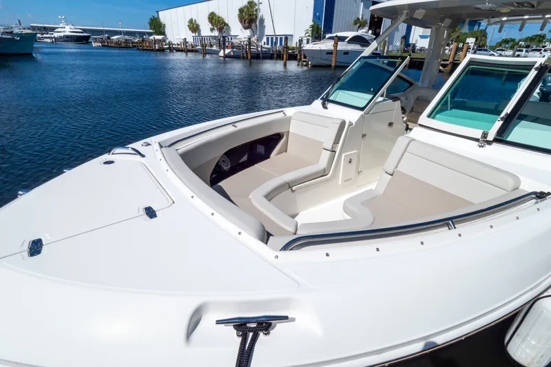 Slide: The Image of 2023 Boston Whaler 280 Vantage boat with spacious seating at a marina. - 75