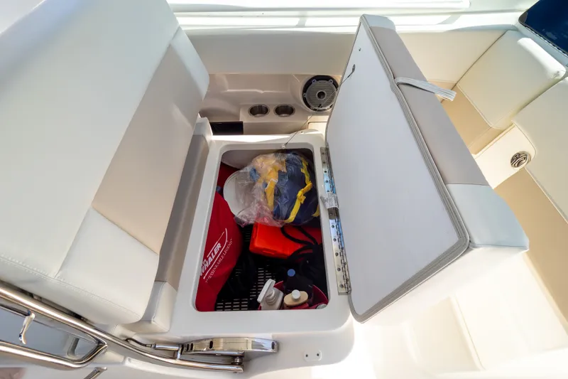 Slide: The Image of Storage compartment on 2023 Boston Whaler 280 Vantage boat, featuring organized gear and accessories. - 56