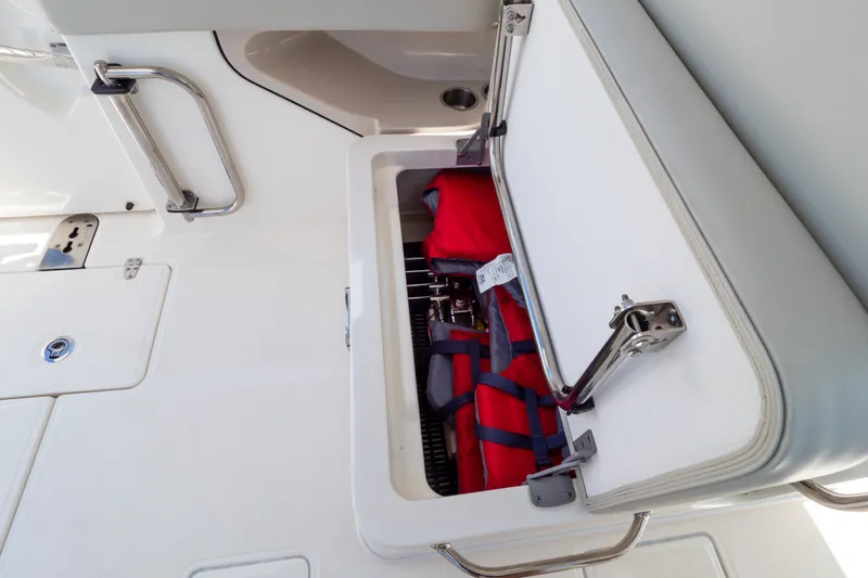 Slide: The Image of Storage compartment on 2023 Boston Whaler 280 Vantage boat with life jackets inside. - 57