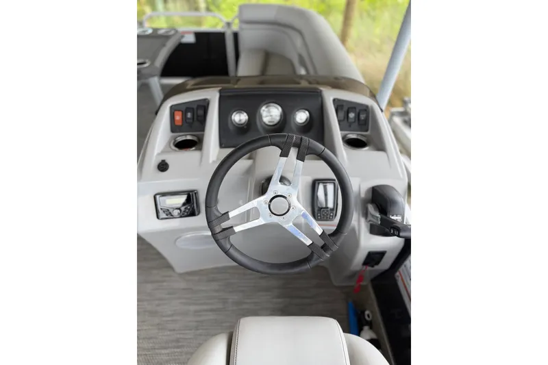 Slide: The Image of 2023 Bennington 22 SV boat dashboard with steering wheel and controls. - 11