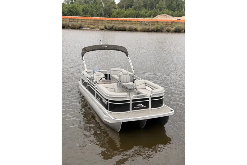 Slide: The Image of 2023 Bennington 22 SV pontoon boat on calm water, featuring sleek design and comfortable seating. - 4