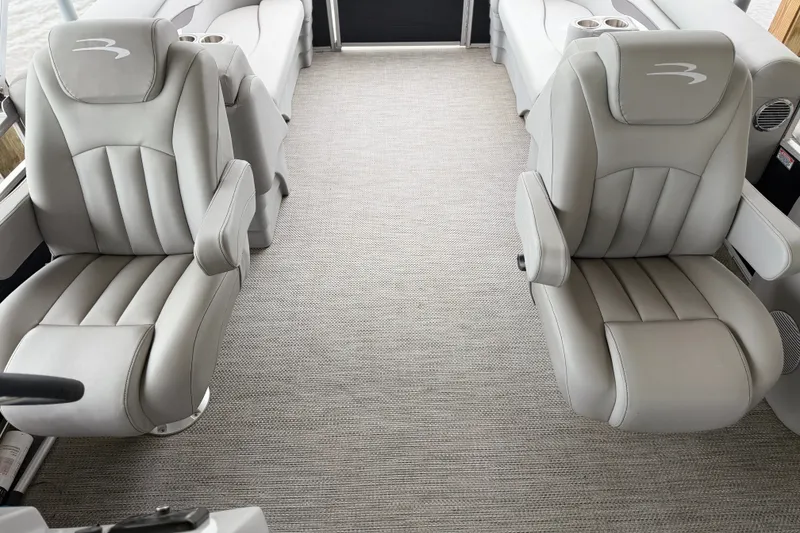 Slide: The Image of 2023 Bennington 22 SV boat interior with plush gray seating and carpeted flooring. - 12