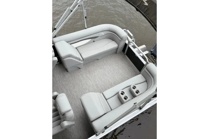 Slide: The Image of 2023 Bennington 22 SV pontoon boat interior with plush seating and cup holders. - 17