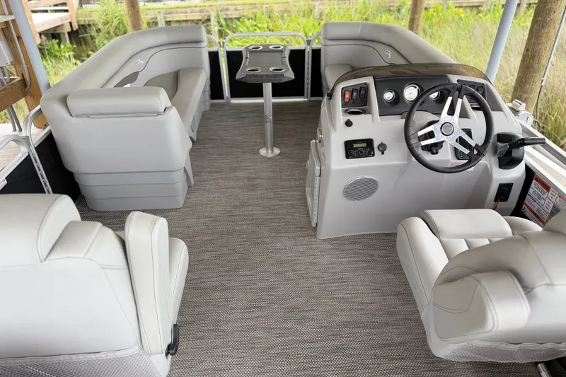 Slide: The Image of 2023 Bennington 22 SV pontoon boat interior with plush seating and modern helm. - 13