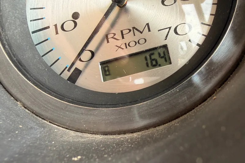 Slide: The Image of Close-up of 2023 Bennington 22 SV RPM gauge displaying 16.4. - 27