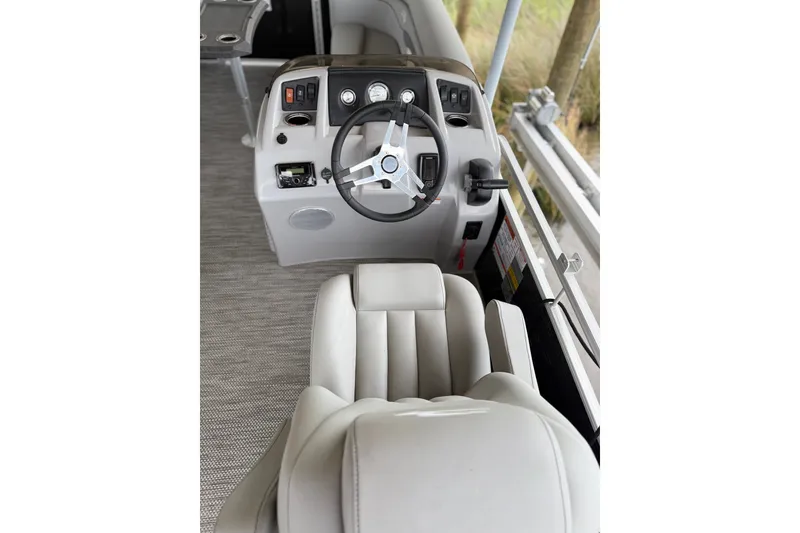 Slide: The Image of 2023 Bennington 22 SV boat interior with steering wheel and captain's chair. - 18