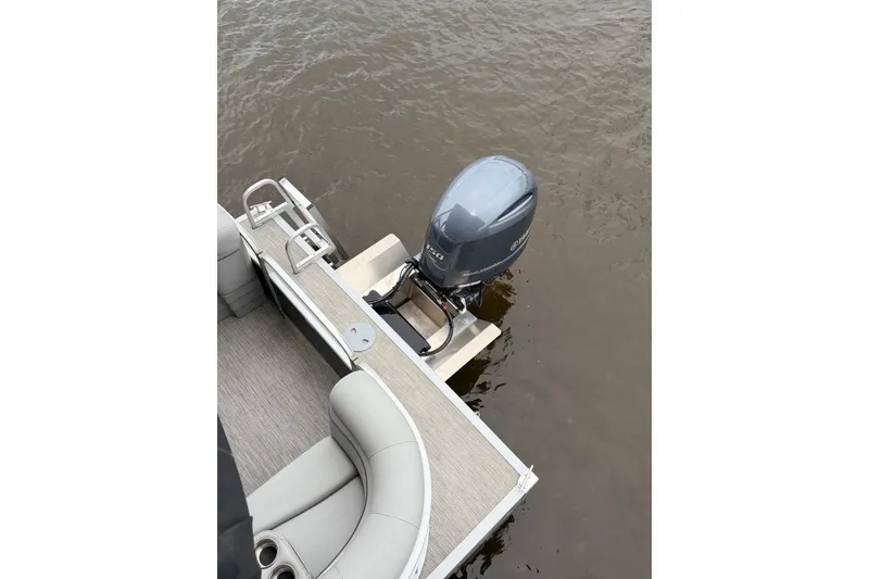 Slide: The Image of 2023 Bennington 22 SV pontoon boat with outboard motor on water. - 22