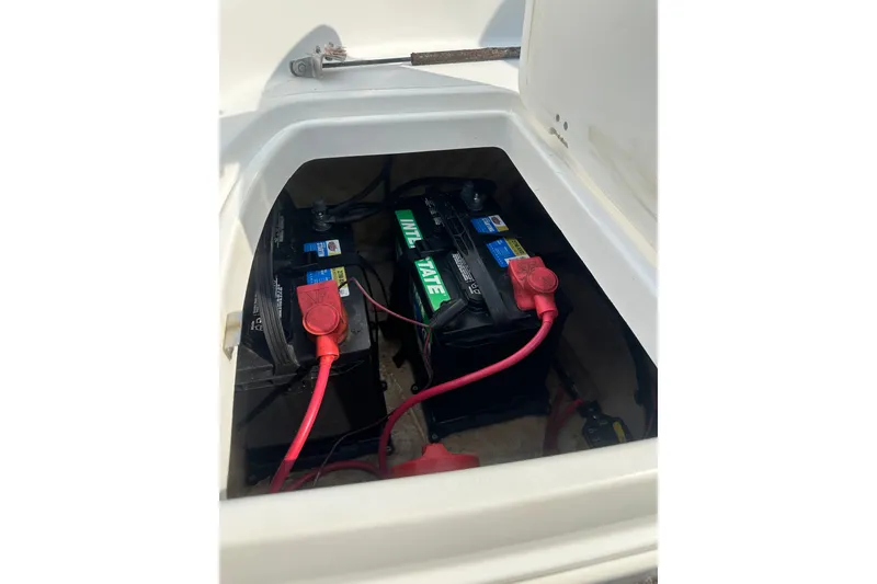 Slide: The Image of 2023 Hurricane SunDeck Sport 192 RL OB boat battery compartment with connected cables. - 30
