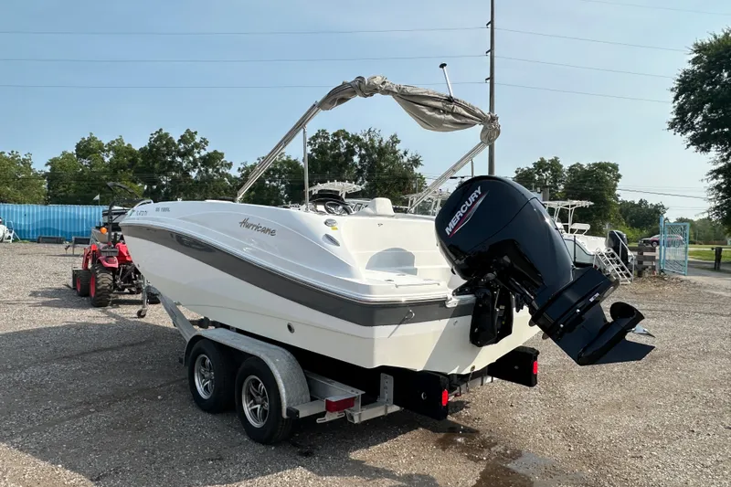 Slide: The Image of 2023 Hurricane SunDeck Sport 192 RL OB boat on trailer, featuring Mercury outboard motor. - 5