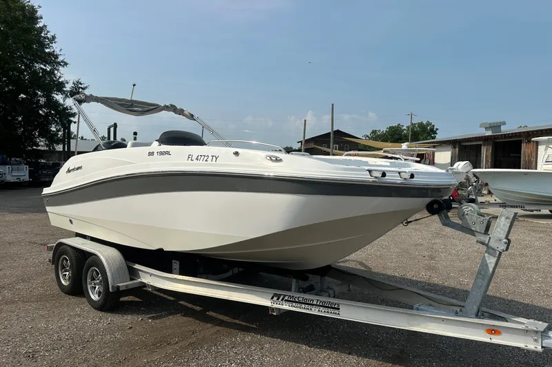 The Image of 2023 Hurricane SunDeck Sport 192 RL OB boat on trailer, parked outdoors. - 0