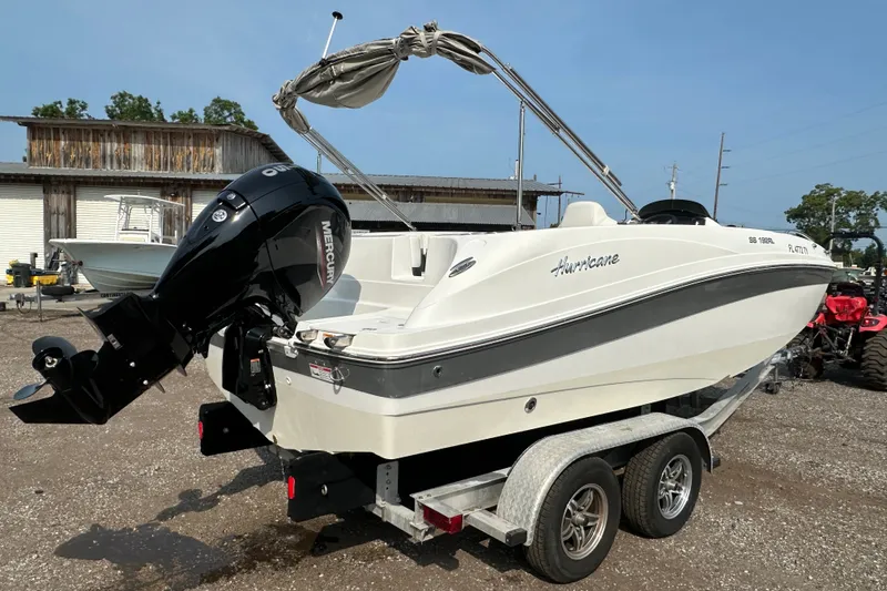 Slide: The Image of 2023 Hurricane SunDeck Sport 192 RL OB boat on trailer, featuring Mercury outboard motor. - 3