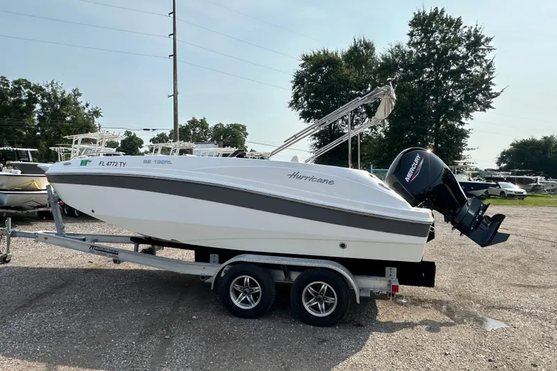 Slide: The Image of 2023 Hurricane SunDeck Sport 192 RL OB boat on trailer, parked outdoors. - 6
