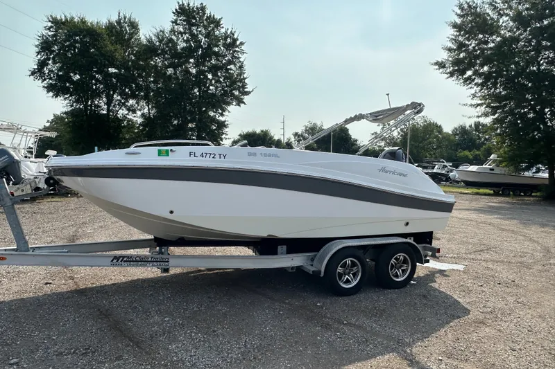 Slide: The Image of 2023 Hurricane SunDeck Sport 192 RL OB boat on trailer in outdoor setting. - 7