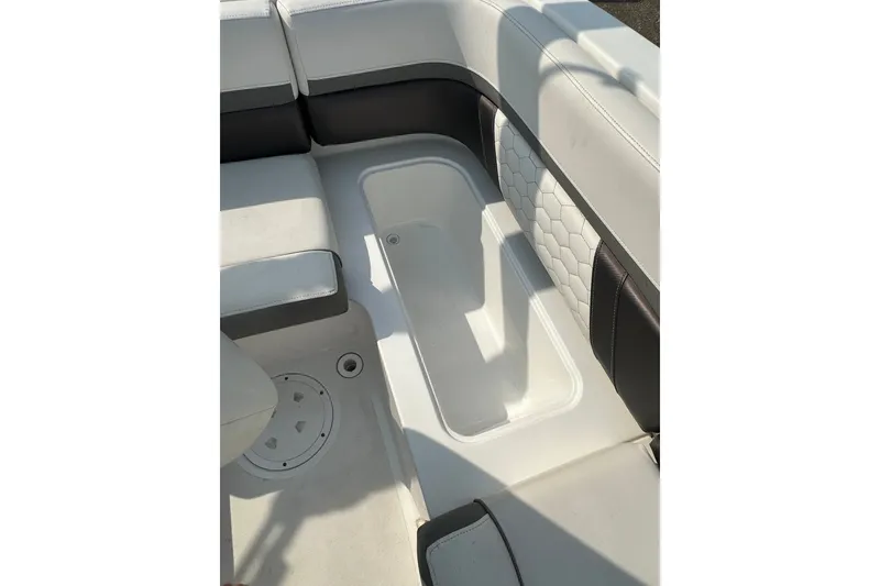 Slide: The Image of 2023 Hurricane SunDeck Sport 192 RL OB interior seating with storage compartment. - 21