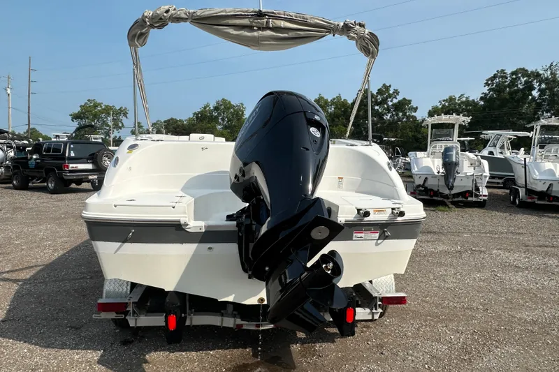 Slide: The Image of 2023 Hurricane SunDeck Sport 192 RL OB boat with outboard motor, parked on gravel lot. - 4