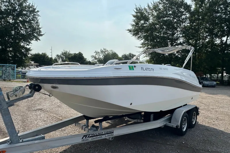 Slide: The Image of 2023 Hurricane SunDeck Sport 192 RL OB boat on trailer, parked outdoors. - 8