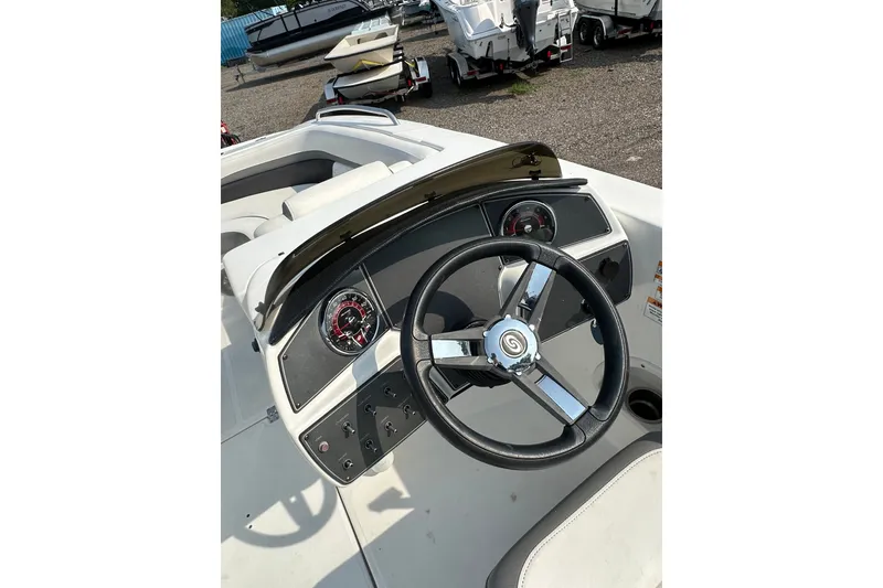 Slide: The Image of 2023 Hurricane SunDeck Sport 192 RL OB boat dashboard with steering wheel and gauges. - 23