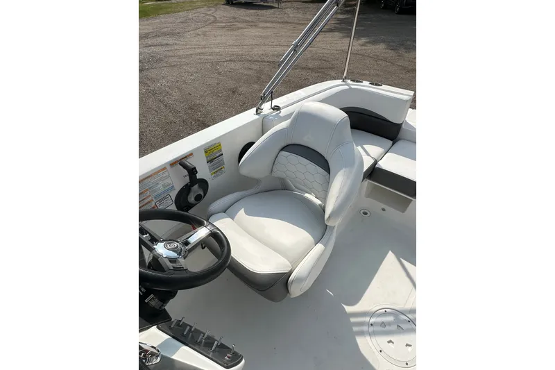 Slide: The Image of 2023 Hurricane SunDeck Sport 192 RL OB boat interior with steering wheel and cushioned seating. - 17