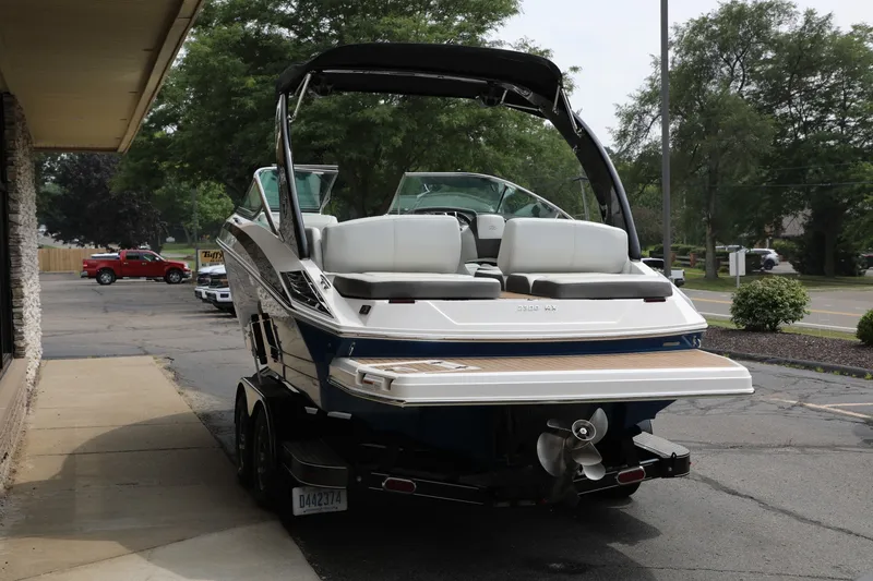 Slide: The Image of 2014 Regal 2300 RX Bowrider boat on trailer, parked outdoors. - 4