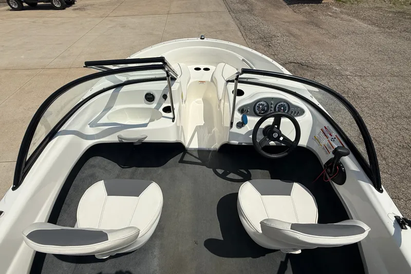 Slide: The Image of 2019 Bayliner 160 Bowrider interior with dual seats, steering wheel, and dashboard controls. - 16