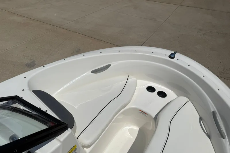 Slide: The Image of 2019 Bayliner 160 Bowrider boat interior with white seating and cup holders. - 10