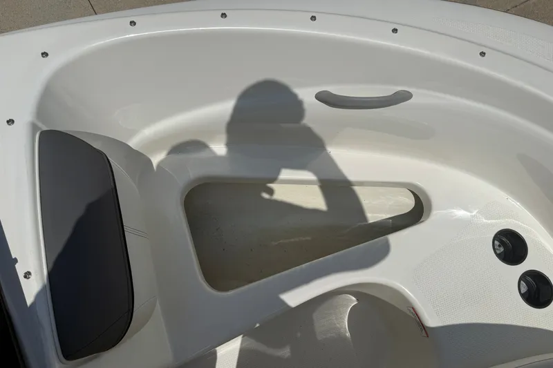 Slide: The Image of 2019 Bayliner 160 Bowrider interior with seating and shadow, showcasing boat design. - 12