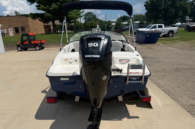 Slide: The Image of 2019 Bayliner 160 Bowrider with Mercury 90 engine, parked outdoors on a sunny day. - 6