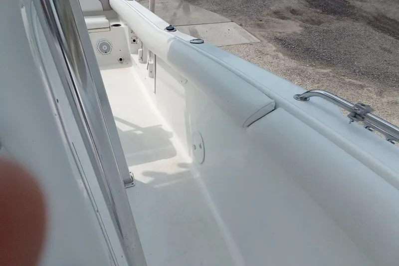 Slide: The Image of 2009 Sea Hunt Ultra 232 boat interior, featuring white seating and deck details. - 29