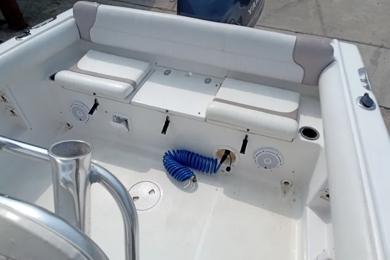 Slide: The Image of 2009 Sea Hunt Ultra 232 boat interior with seating and coiled blue hose. - 30