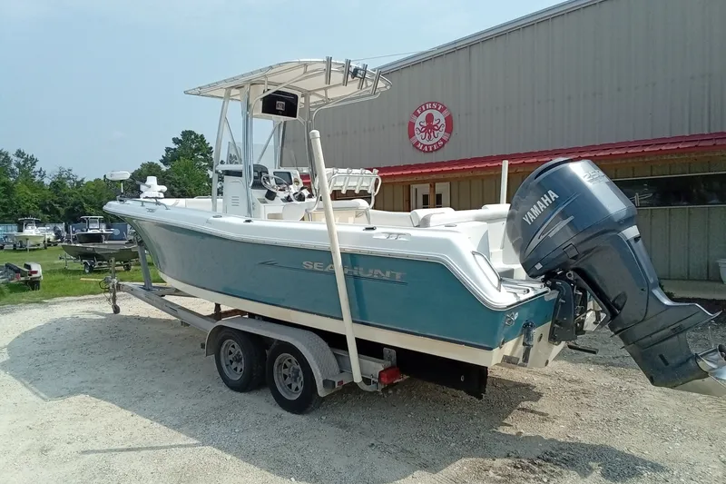 Slide: The Image of 2009 Sea Hunt Ultra 232 boat with Yamaha engine on trailer, parked outside a building. - 13