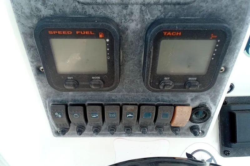 Slide: The Image of Dashboard of a 2009 Sea Hunt Ultra 232 boat with speed, fuel, and tachometer gauges. - 31