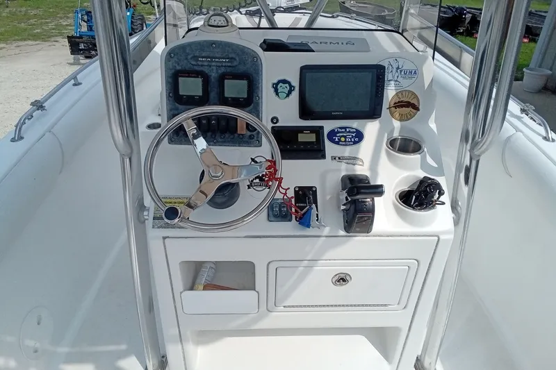 Slide: The Image of 2009 Sea Hunt Ultra 232 boat console with steering wheel and navigation equipment. - 20