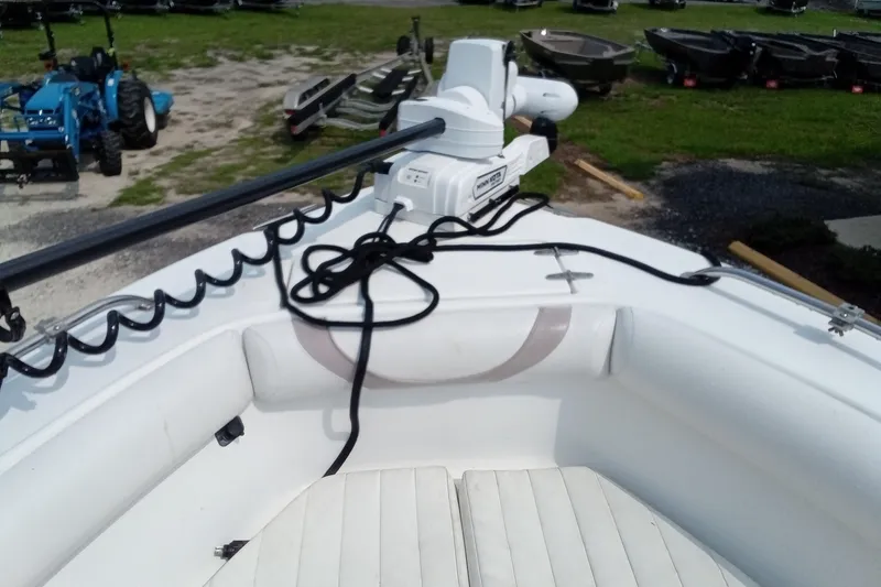 Slide: The Image of 2009 Sea Hunt Ultra 232 boat with trolling motor and seating, parked on grass. - 25
