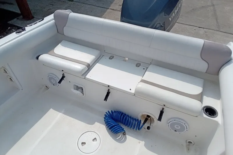 Slide: The Image of 2009 Sea Hunt Ultra 232 boat interior with seating and Yamaha engine. - 19
