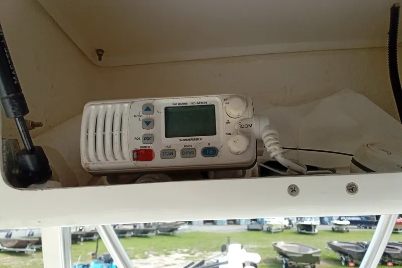 Slide: The Image of VHF marine radio on 2009 Sea Hunt Ultra 232 boat dashboard. - 34