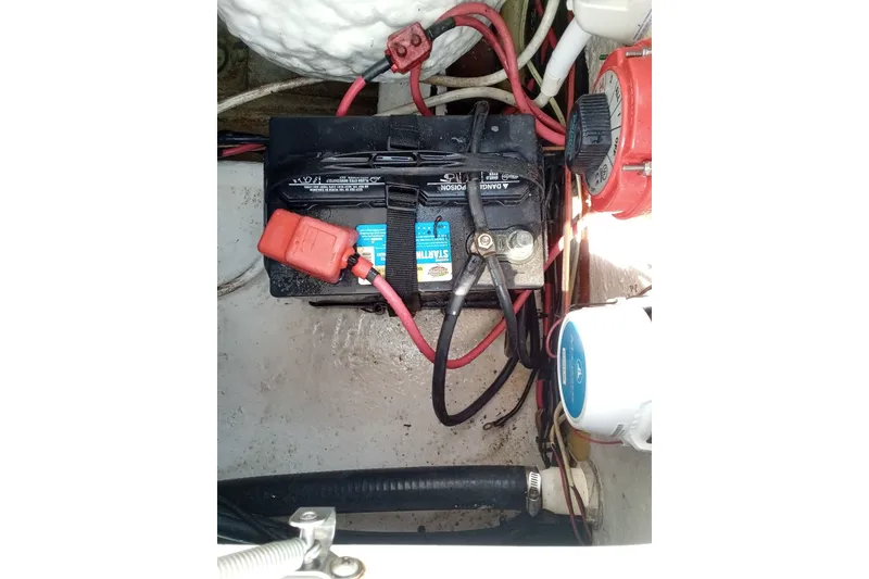 Slide: The Image of Battery compartment of a 2009 Sea Hunt Ultra 232 boat with wiring connections. - 18