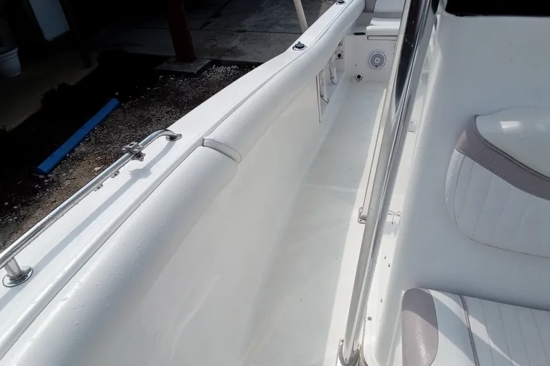 Slide: The Image of 2009 Sea Hunt Ultra 232 boat interior with white seating and stainless steel railing. - 28