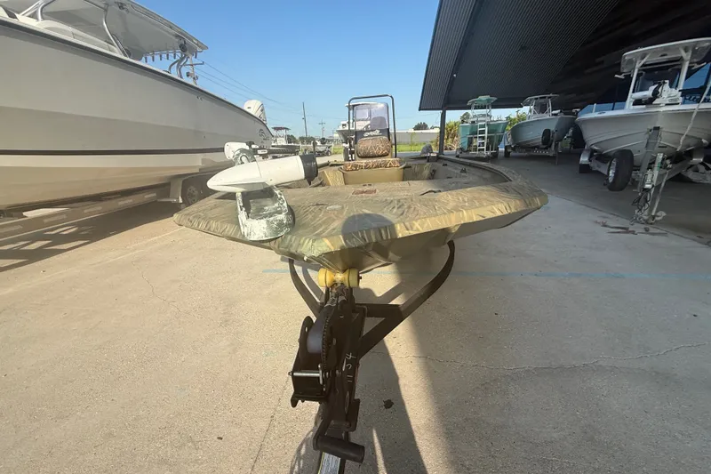 Slide: The Image of 2019 Tracker Grizzly 1860 boat parked in a marina with other vessels. - 8