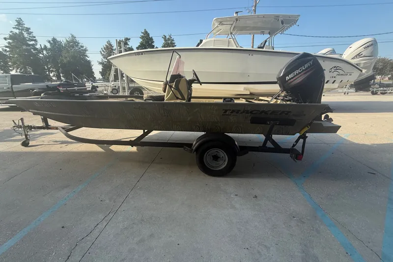 Slide: The Image of 2019 Tracker Grizzly 1860 boat on trailer with Mercury outboard motor. - 6