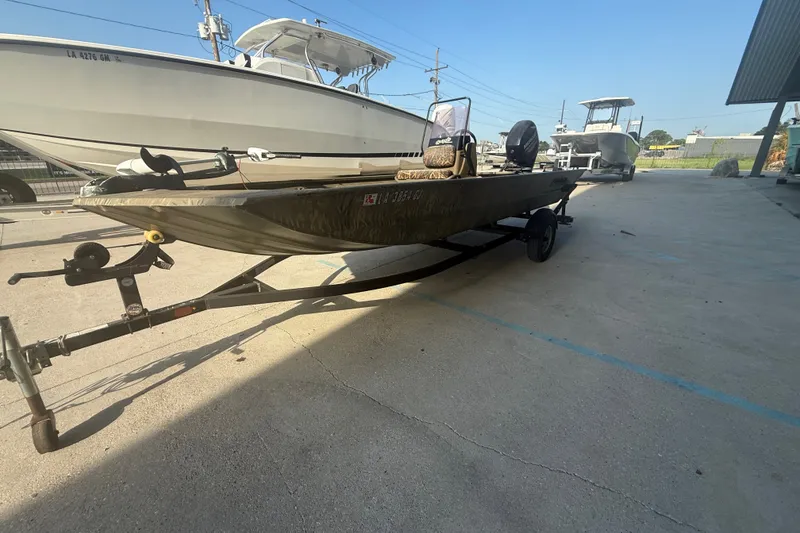 Slide: The Image of 2019 Tracker Grizzly 1860 boat on trailer in outdoor setting. - 7