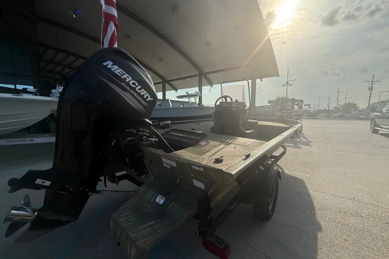 Slide: The Image of 2019 Tracker Grizzly 1860 boat with Mercury outboard motor in a sunlit outdoor setting. - 3