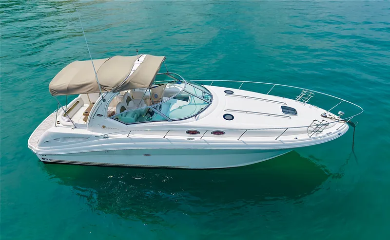 Slide: The Image of A white 2006 Sea Ray 340 Sundancer on calm water with a beige sunshade. - 0