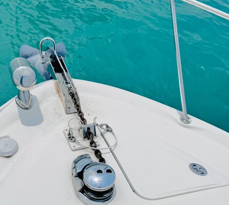 Slide: The Image of The bow of a 2006 Sea Ray 340 Sundancer with anchor windlass and chain in turquoise water. - 5