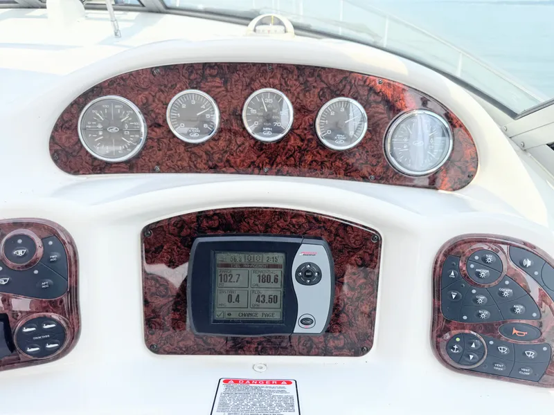 Slide: The Image of The dashboard of a 2006 Sea Ray 340 Sundancer with multiple gauges and a navigation system. - 25