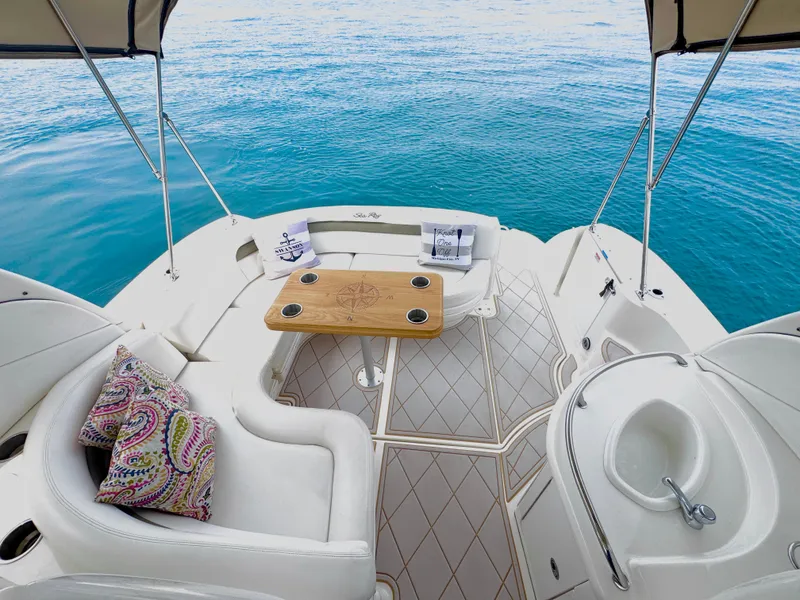 Slide: The Image of The image shows the aft of a 2006 Sea Ray 340 Sundancer with an elegant seating area. - 10