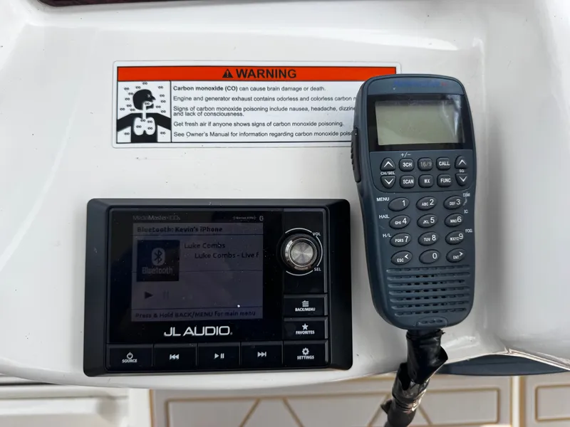 Slide: The Image of A JL Audio system and a radio are mounted on a boat. A warning label is visible. - 23