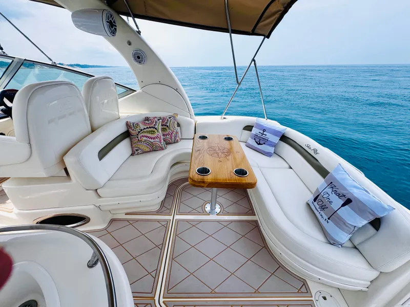 Slide: The Image of The image shows the cockpit of a 2006 Sea Ray 340 Sundancer with comfortable seating and a wooden table. - 11