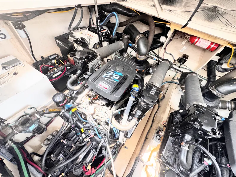 Slide: The Image of The engine room of a 2006 Sea Ray 340 Sundancer shows two large engines and wiring. - 40