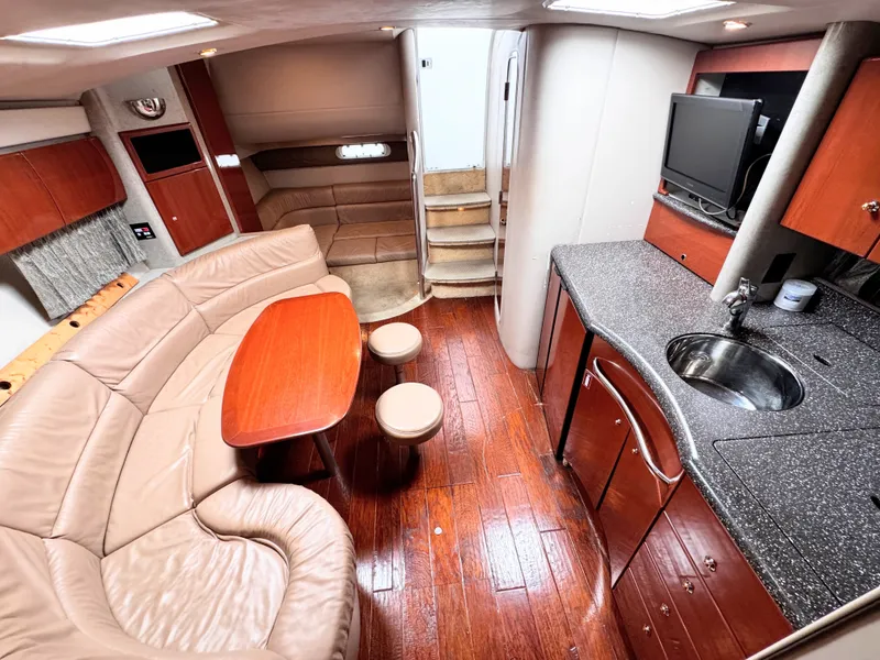 Slide: The Image of Interior of a 2004 Formula 40 Performance Cruiser with elegant leather couch, wooden table, and kitchenette. - 20